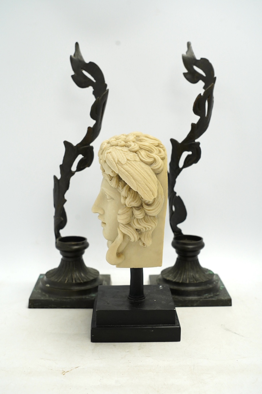 A decorative resin bust of Medusa and a pair of brass candle stands, 40cm. Condition - fair